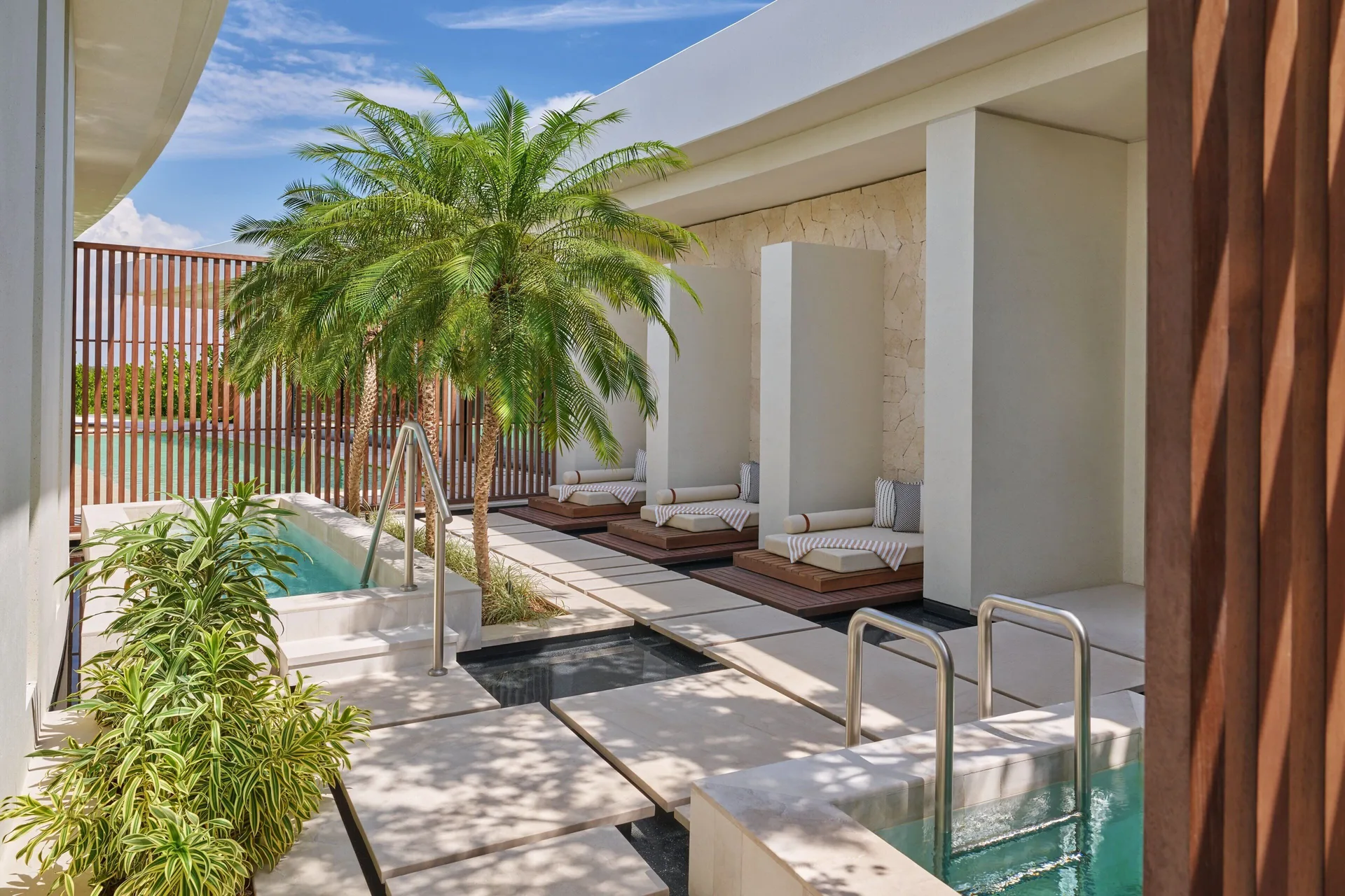 Spa courtyard with plunge pools and loungers at The St. Regis Kanai Resort, Riviera Maya.
