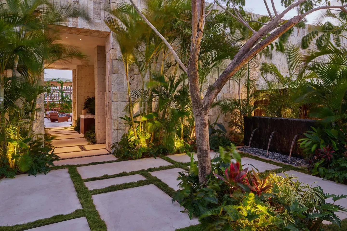 Tropical garden walkway and water wall at The St. Regis Kanai Resort, Riviera Maya.