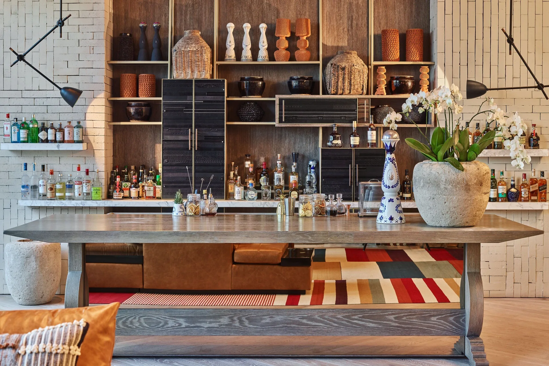 Back bar with bottles, shelves and orchids at The St. Regis Kanai Resort, Riviera Maya.