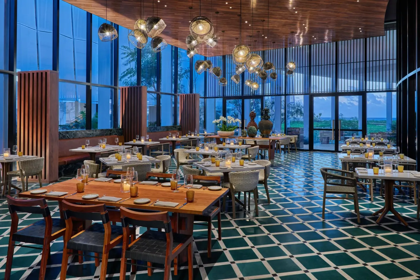 Elegant dining room with patterned tile floor and ocean-facing windows at The St. Regis Kanai Resort, Riviera Maya.