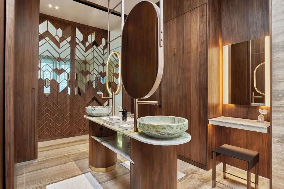 Deluxe Room bathroom vanity with vessel sinks and wood screens at The St. Regis Kanai Resort, Riviera Maya.