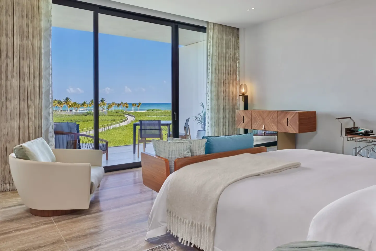 Deluxe Room king bed facing terrace doors and ocean view at The St. Regis Kanai Resort, Riviera Maya.
