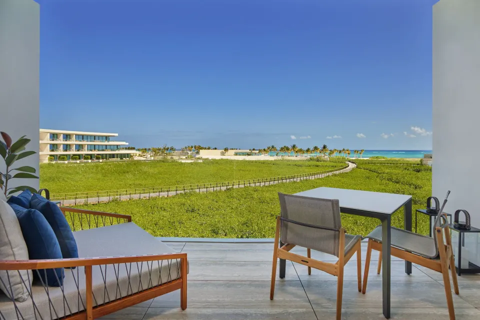 Deluxe Room terrace with seating and ocean view at The St. Regis Kanai Resort, Riviera Maya.