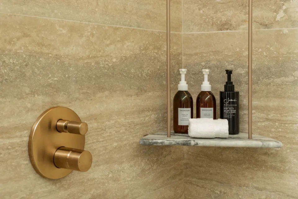 Shower shelf with bath amenities in a Grand Room at The St. Regis Kanai Resort, Riviera Maya.