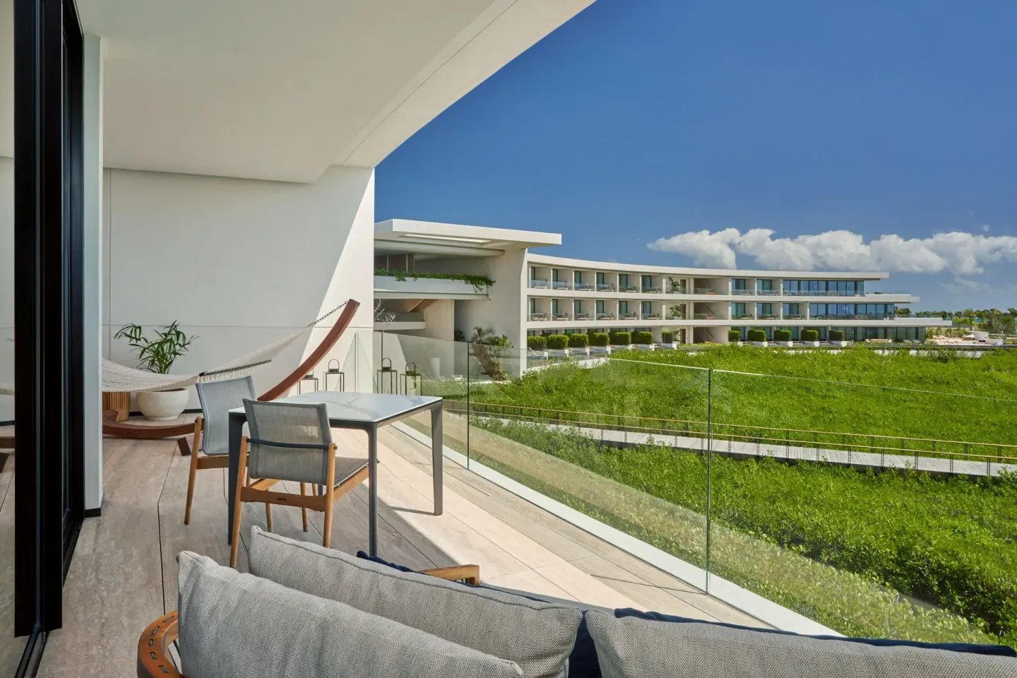 Furnished balcony with hammock and resort views at The St. Regis Kanai Resort, Riviera Maya.