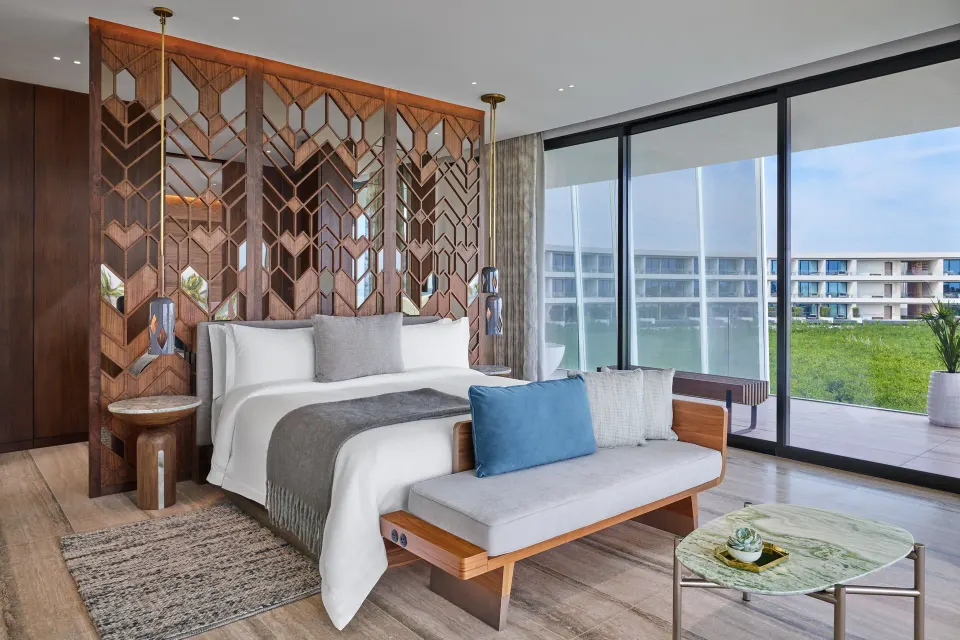 King bed and terrace windows in an Ocean View Suite at The St. Regis Kanai Resort, Riviera Maya.
