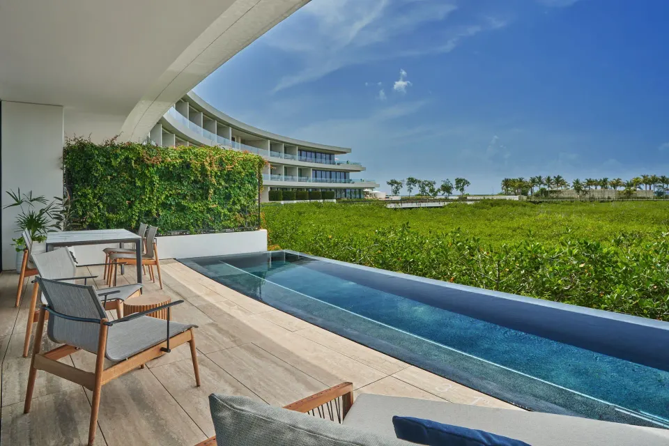 Private pool terrace of an Ocean View Suite at The St. Regis Kanai Resort overlooking greenery.