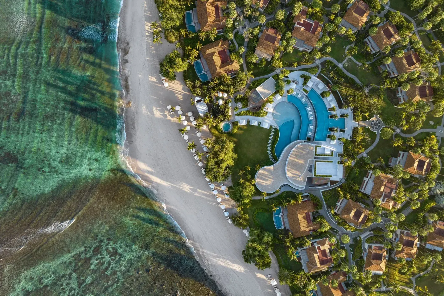 Aerial view of beach, pools, villas and gardens at The St. Regis Punta Mita Resort.
