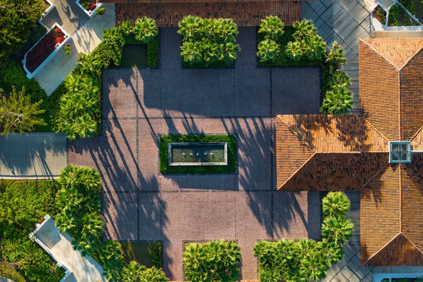 Overhead view of a landscaped courtyard and tiled roofs at The St. Regis Punta Mita Resort.
