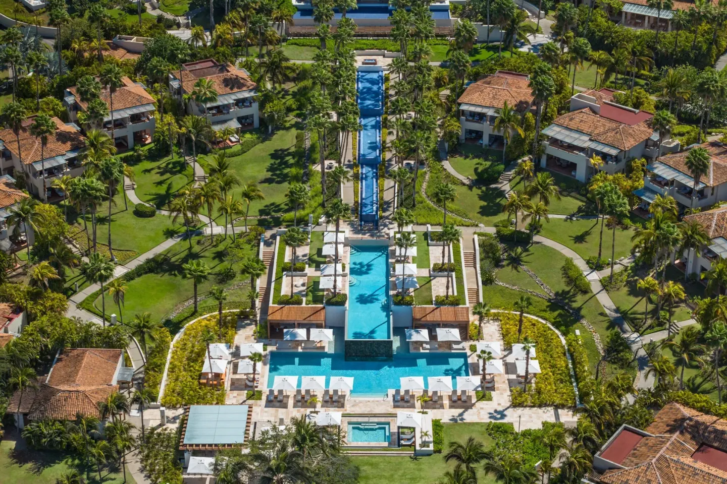 Aerial view of pools, palms, and villas at The St. Regis Punta Mita Resort.