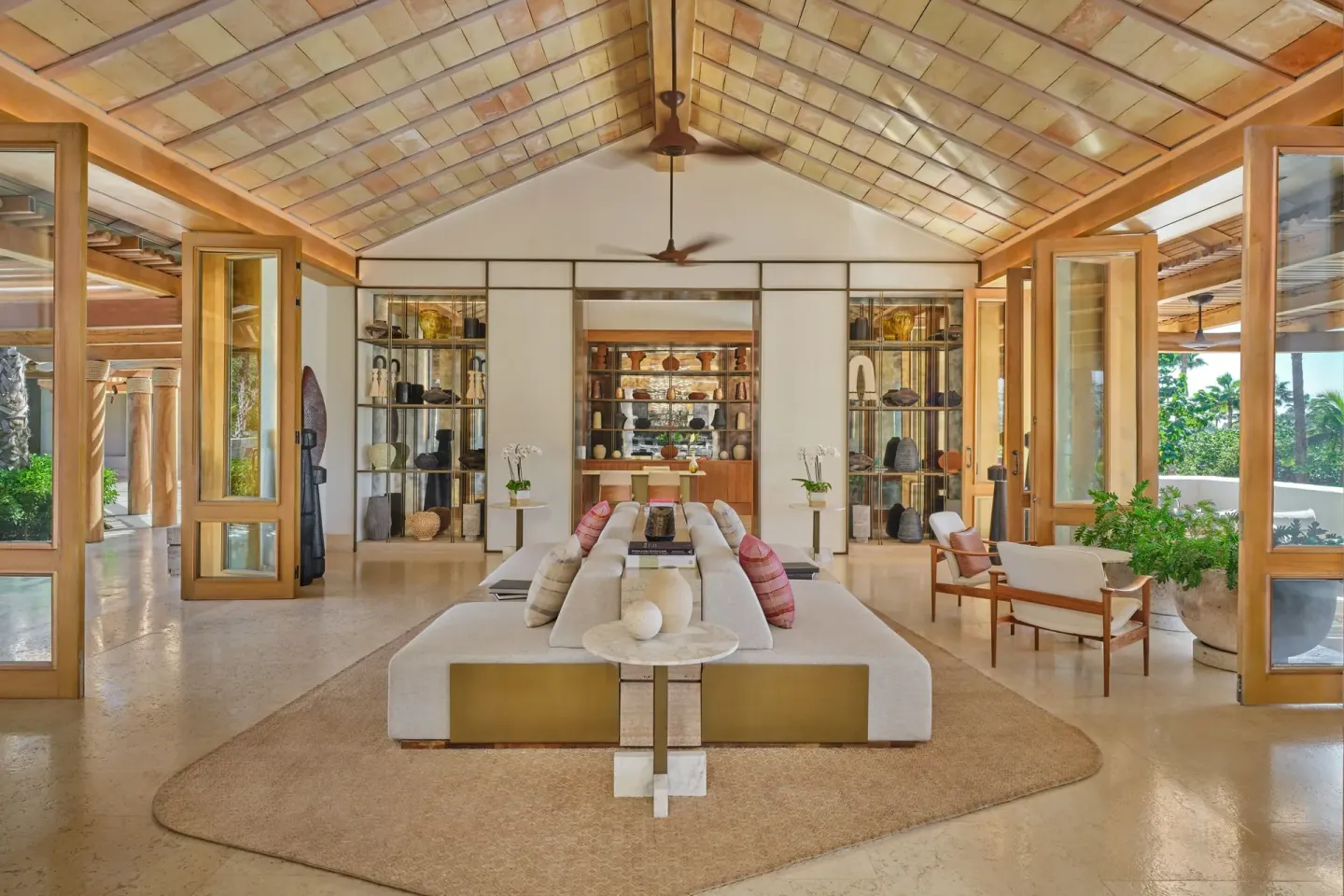 Lounge seating, open doors and display shelves in the lobby at The St. Regis Punta Mita Resort.