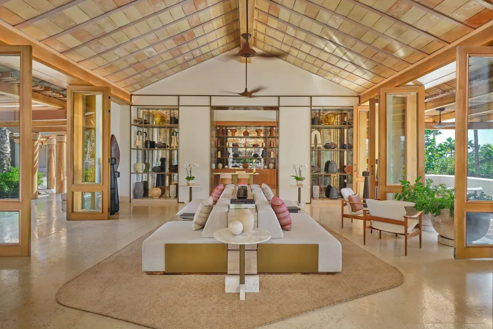 Lounge seating, open doors and display shelves in the lobby at The St. Regis Punta Mita Resort.