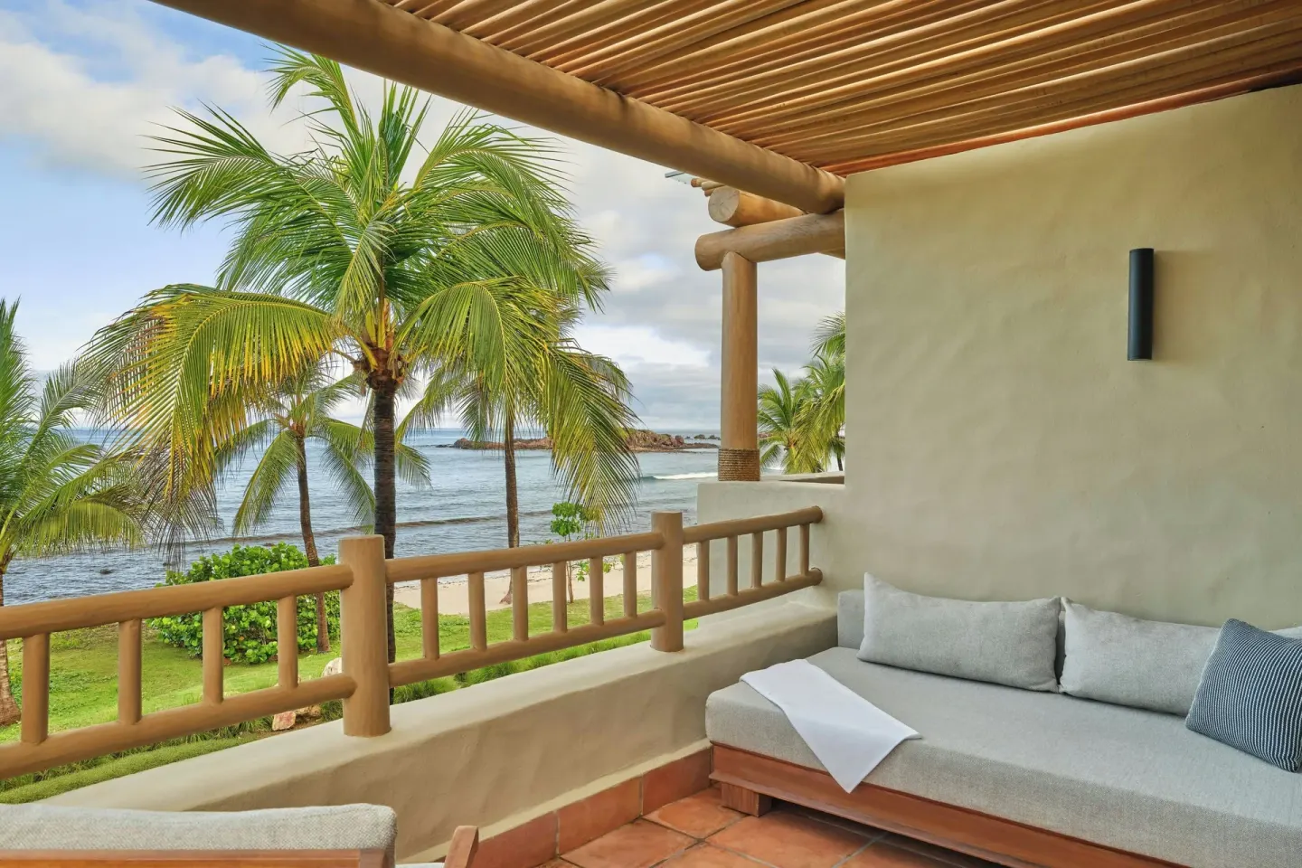 Ocean-view terrace with cushioned seating at The St. Regis Punta Mita Resort.