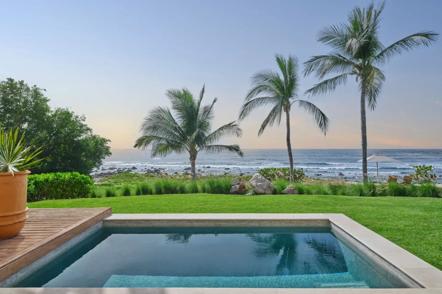 Private plunge pool, lawn, palms and ocean at The St. Regis Punta Mita Resort.