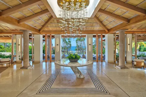 Open lobby with a hanging chandelier and ocean view at The St. Regis Punta Mita Resort.