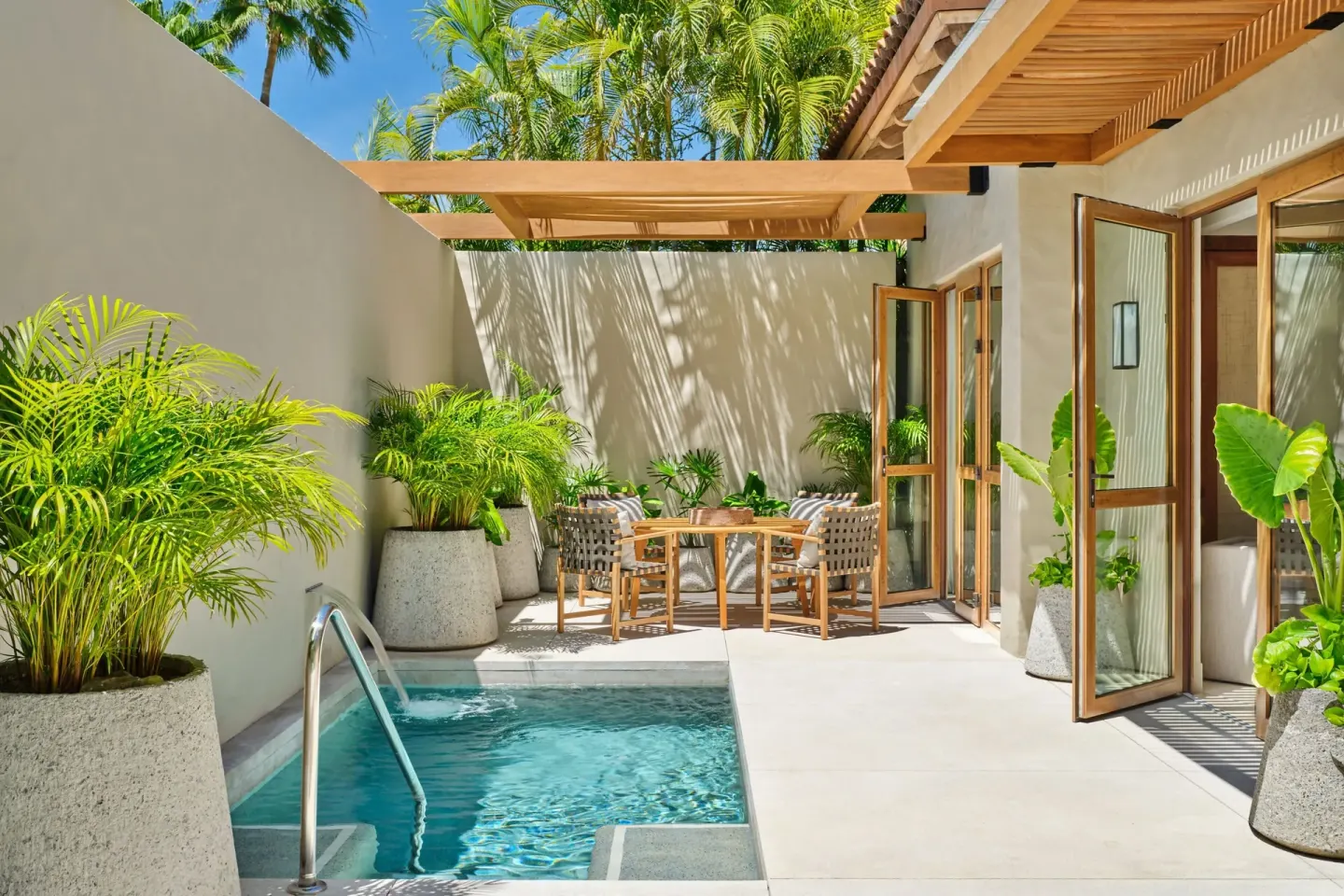 Private patio with plunge pool, dining set and open doors at The St. Regis Punta Mita Resort.