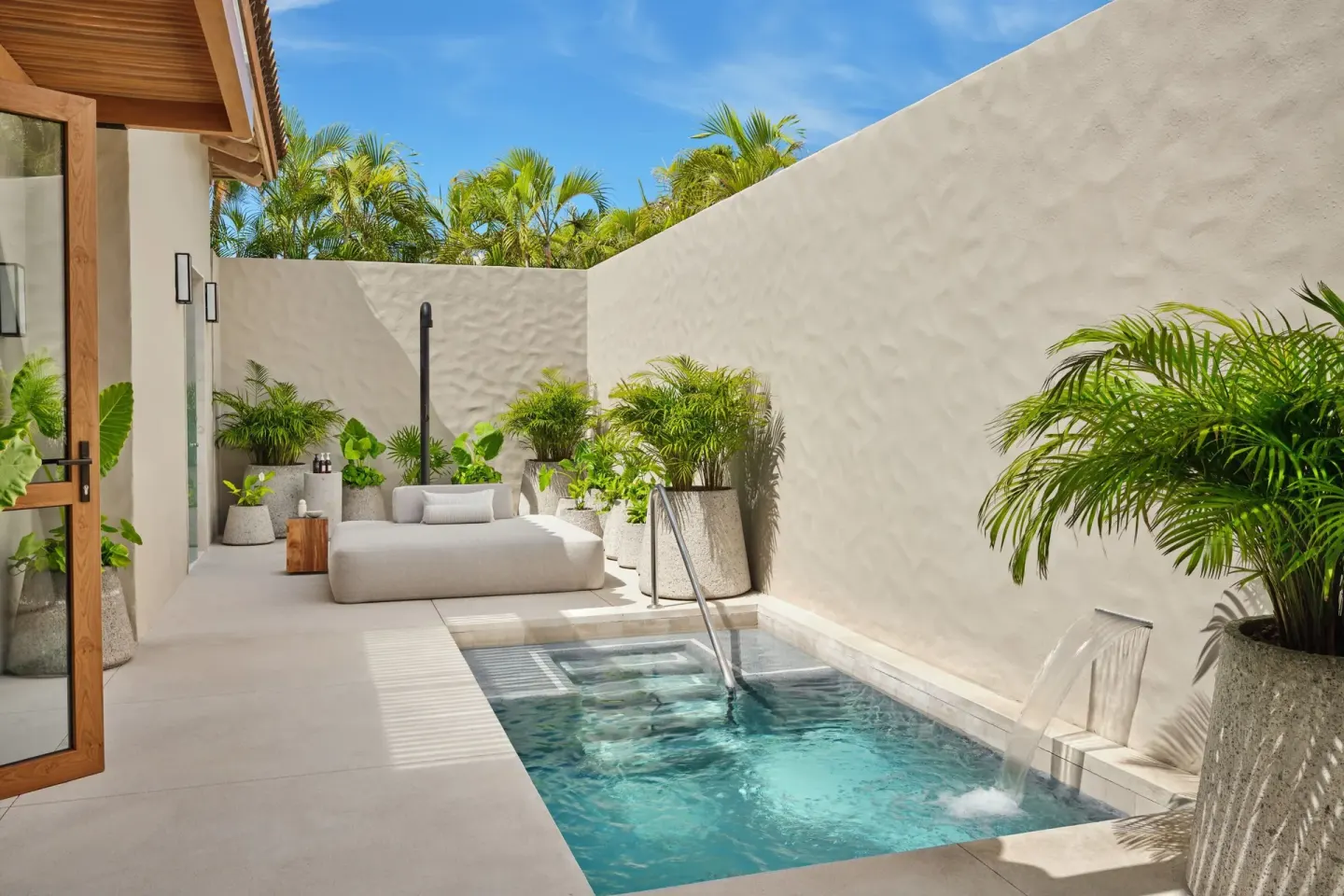 Walled terrace with plunge pool, water feature and daybed at The St. Regis Punta Mita Resort.