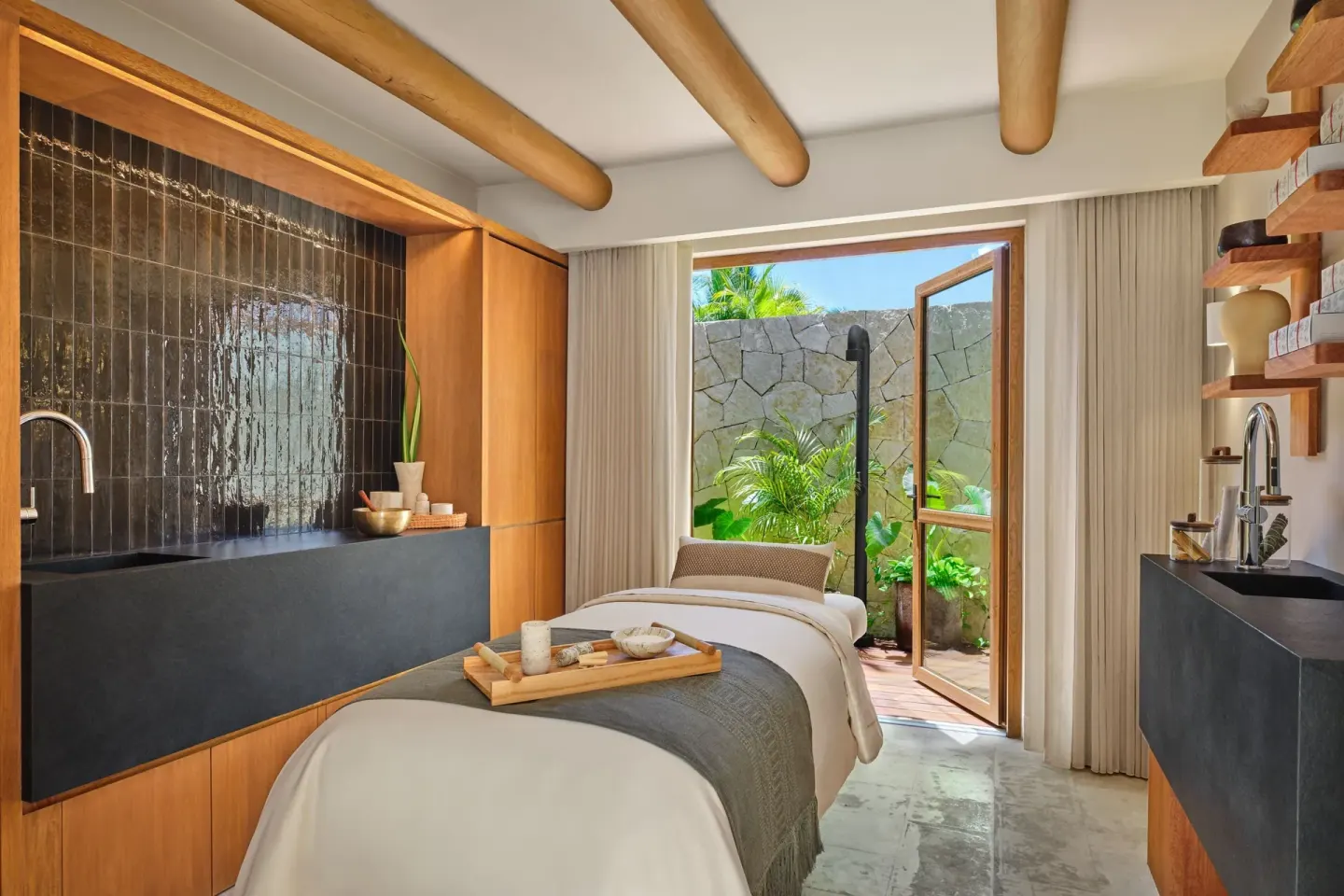 Spa treatment room with a single massage bed at The St. Regis Punta Mita Resort.