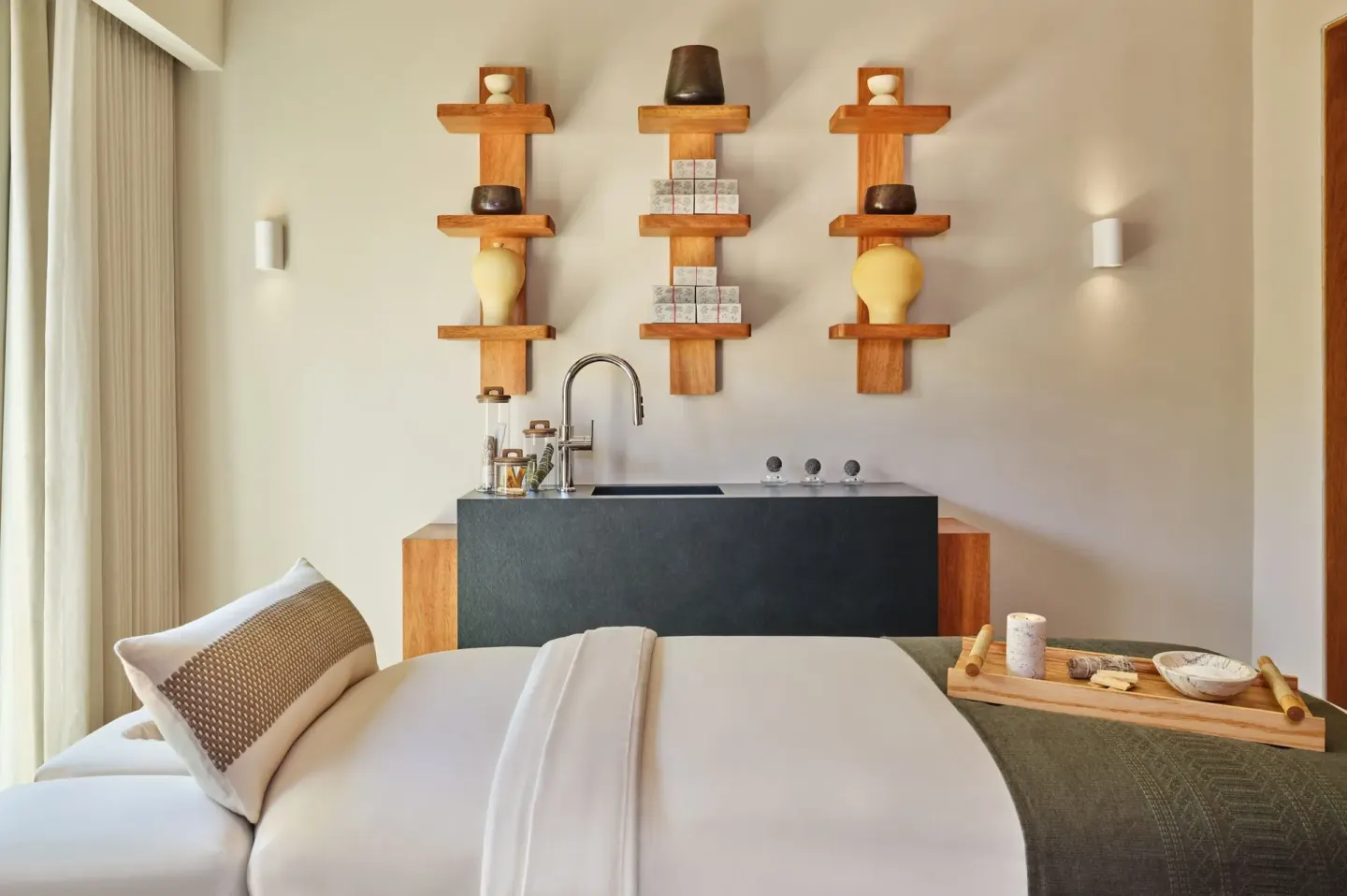 Spa treatment bed with wall shelves and sink at The St. Regis Punta Mita Resort.