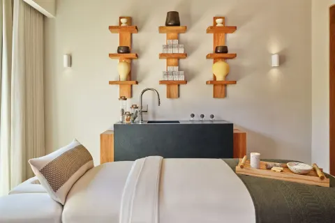 Spa treatment bed with wall shelves and sink at The St. Regis Punta Mita Resort.