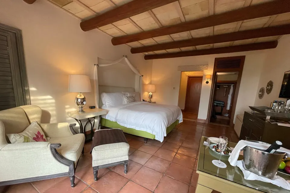 Casita Room Garden View king bed and seating area at The St. Regis Punta Mita Resort.