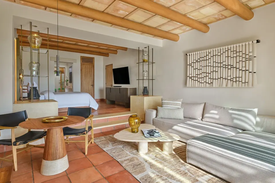 Junior Suite Garden View living area and king bed at The St. Regis Punta Mita Resort.