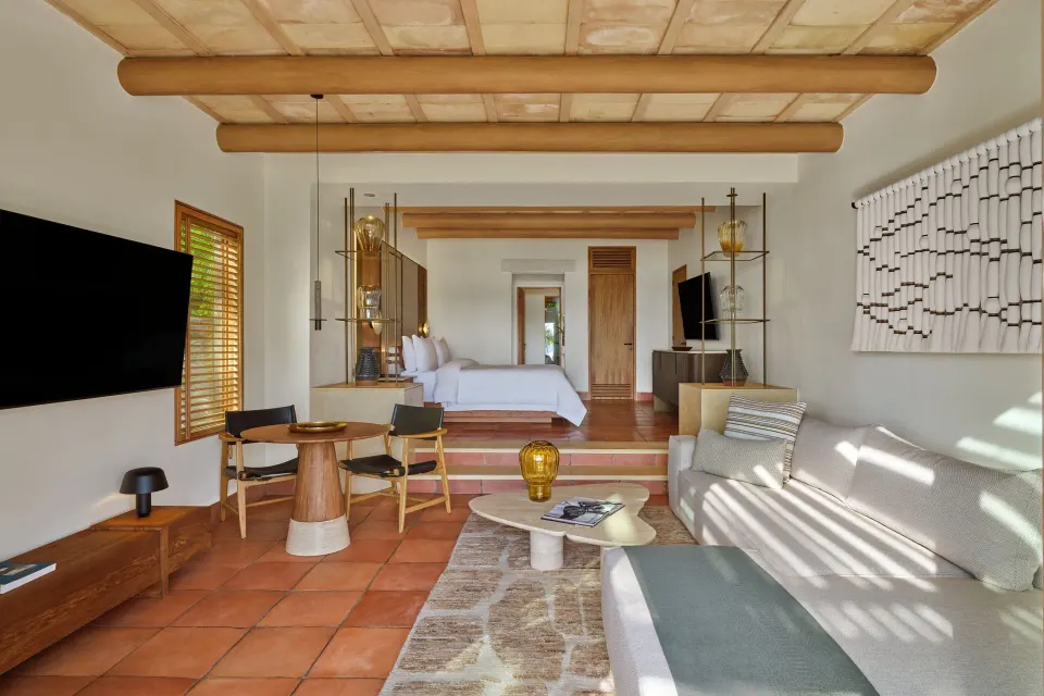 Junior Suite Garden View with lounge seating and king bed at The St. Regis Punta Mita Resort.