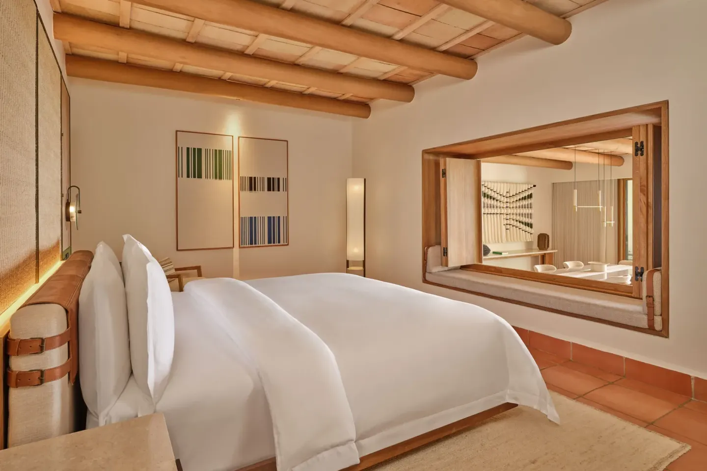 King bed and interior window in a suite at The St. Regis Punta Mita Resort.
