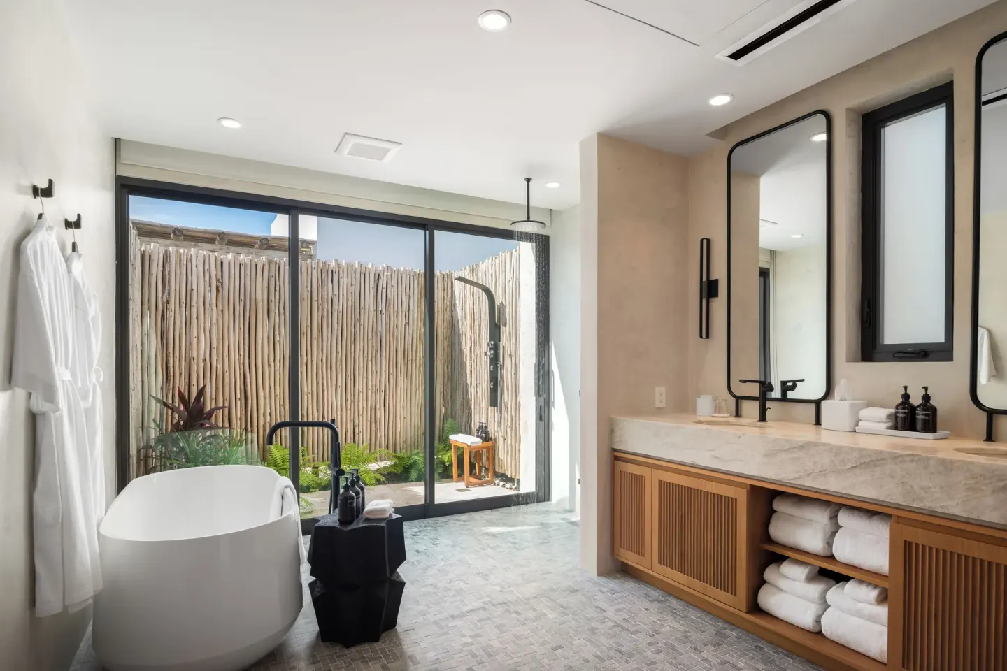 Spacious bathroom with soaking tub and private outdoor shower at The Strand Turks and Caicos.