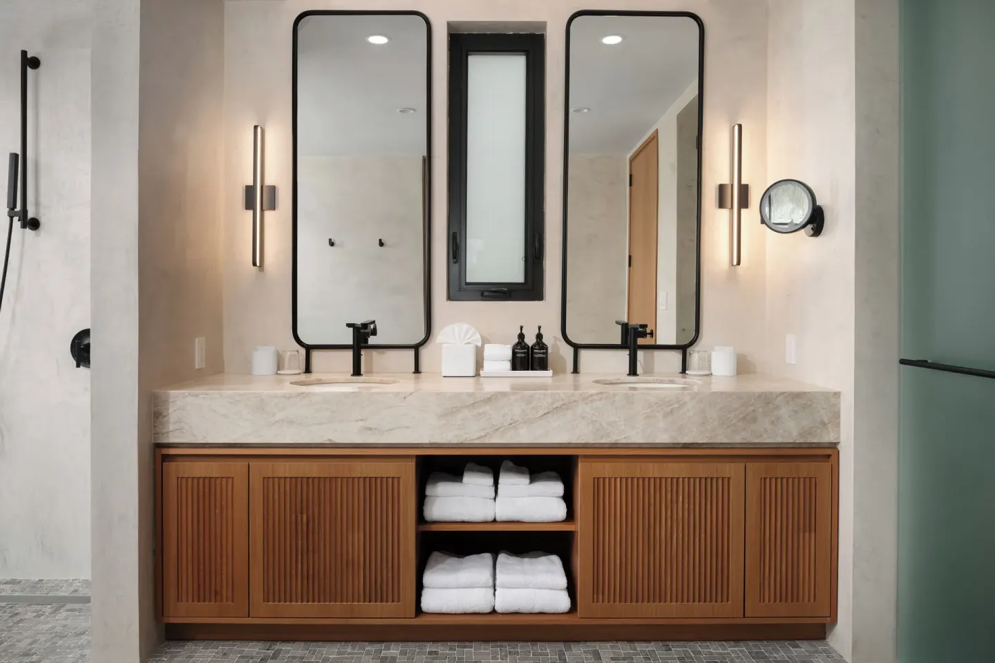 Double vanity bathroom with twin mirrors and walk-in shower at The Strand Turks and Caicos.
