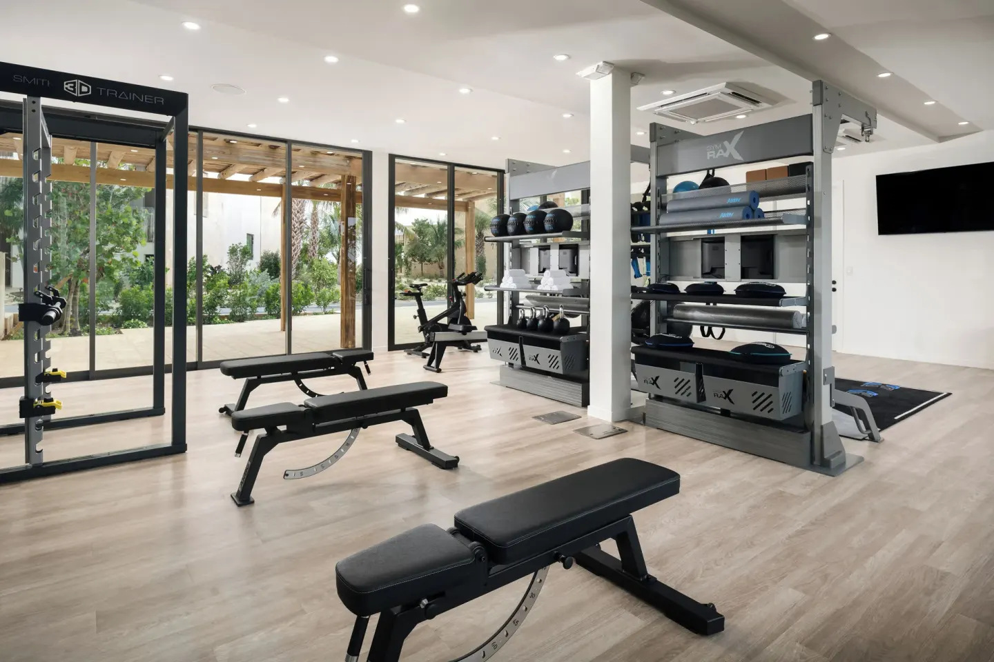 Fitness room with benches, racks, and garden-facing windows at The Strand Turks and Caicos.
