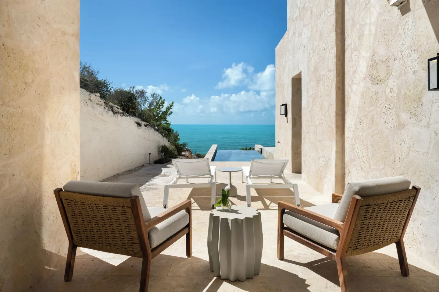 Ocean-facing terrace with lounge chairs and plunge pool at The Strand Turks and Caicos.