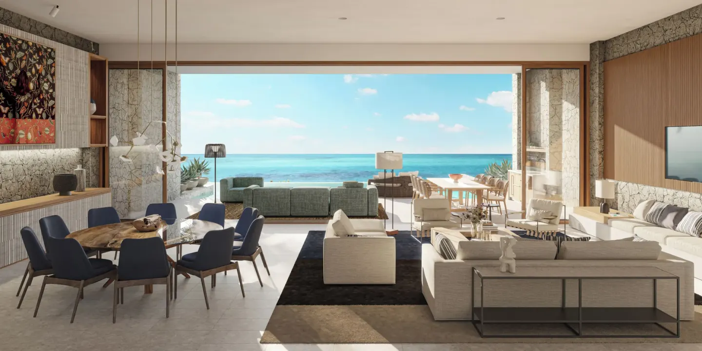 Oceanfront great room with dining and lounge seating at The Strand Turks and Caicos.
