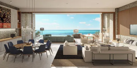 Oceanfront great room with dining and lounge seating at The Strand Turks and Caicos.