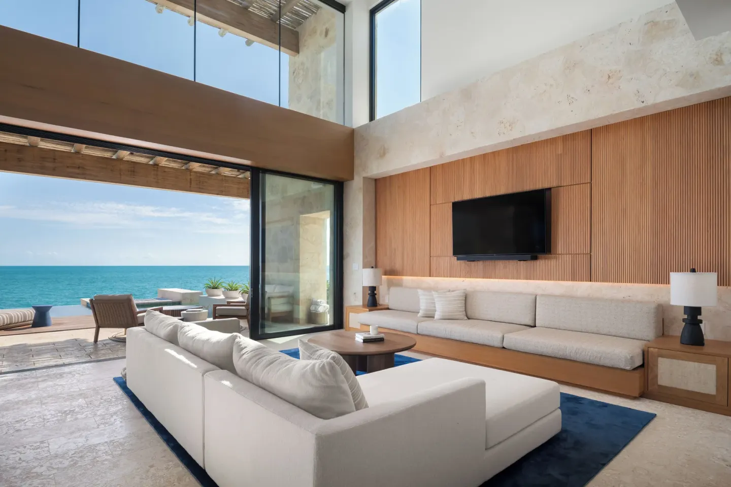 Oceanfront living room with terrace access at The Strand Turks and Caicos.