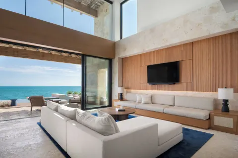 Oceanfront living room with terrace access at The Strand Turks and Caicos.