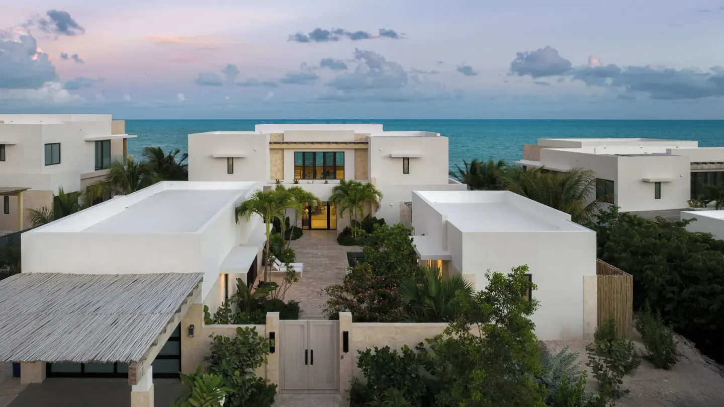 Aerial view of white resort villas by the ocean at The Strand Turks and Caicos.