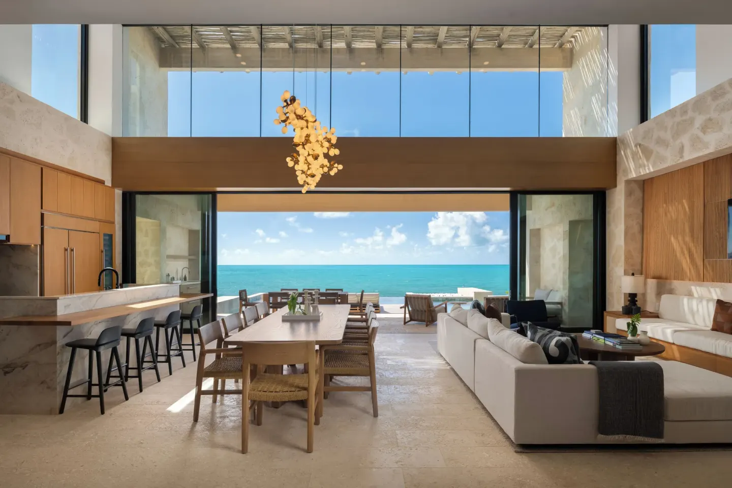 Open-plan oceanfront villa living and dining area at The Strand Turks and Caicos.