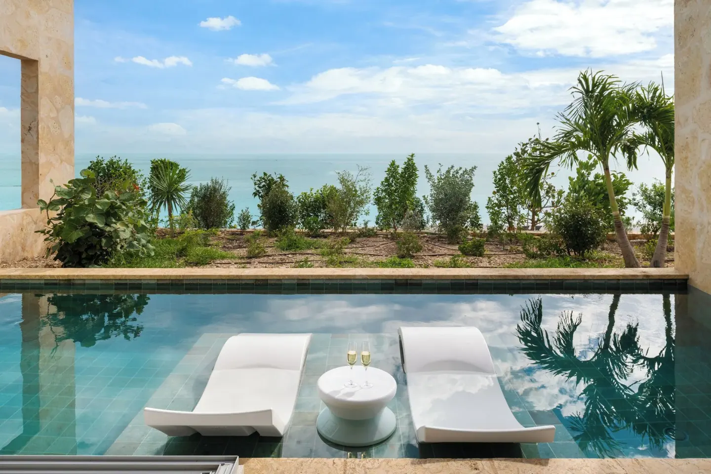Private plunge pool with loungers and ocean view at The Strand Turks and Caicos.