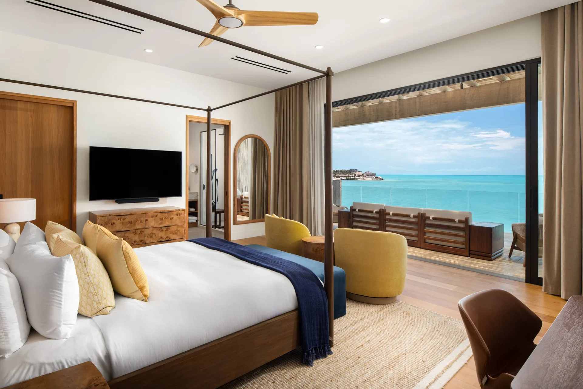 Four-poster king bedroom with ocean balcony at The Strand Turks and Caicos.
