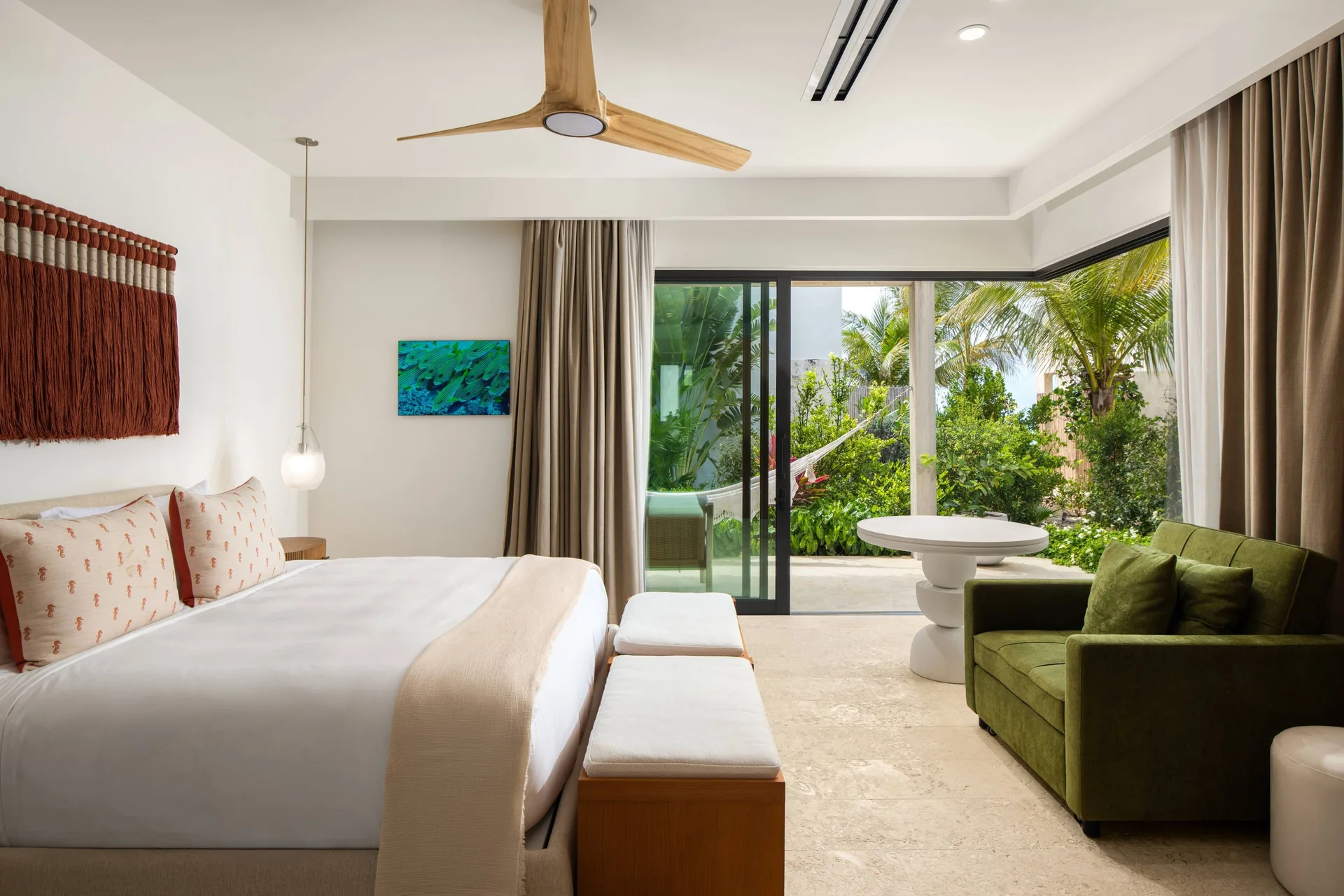 Garden-level king bedroom with sofa and patio at The Strand Turks and Caicos.