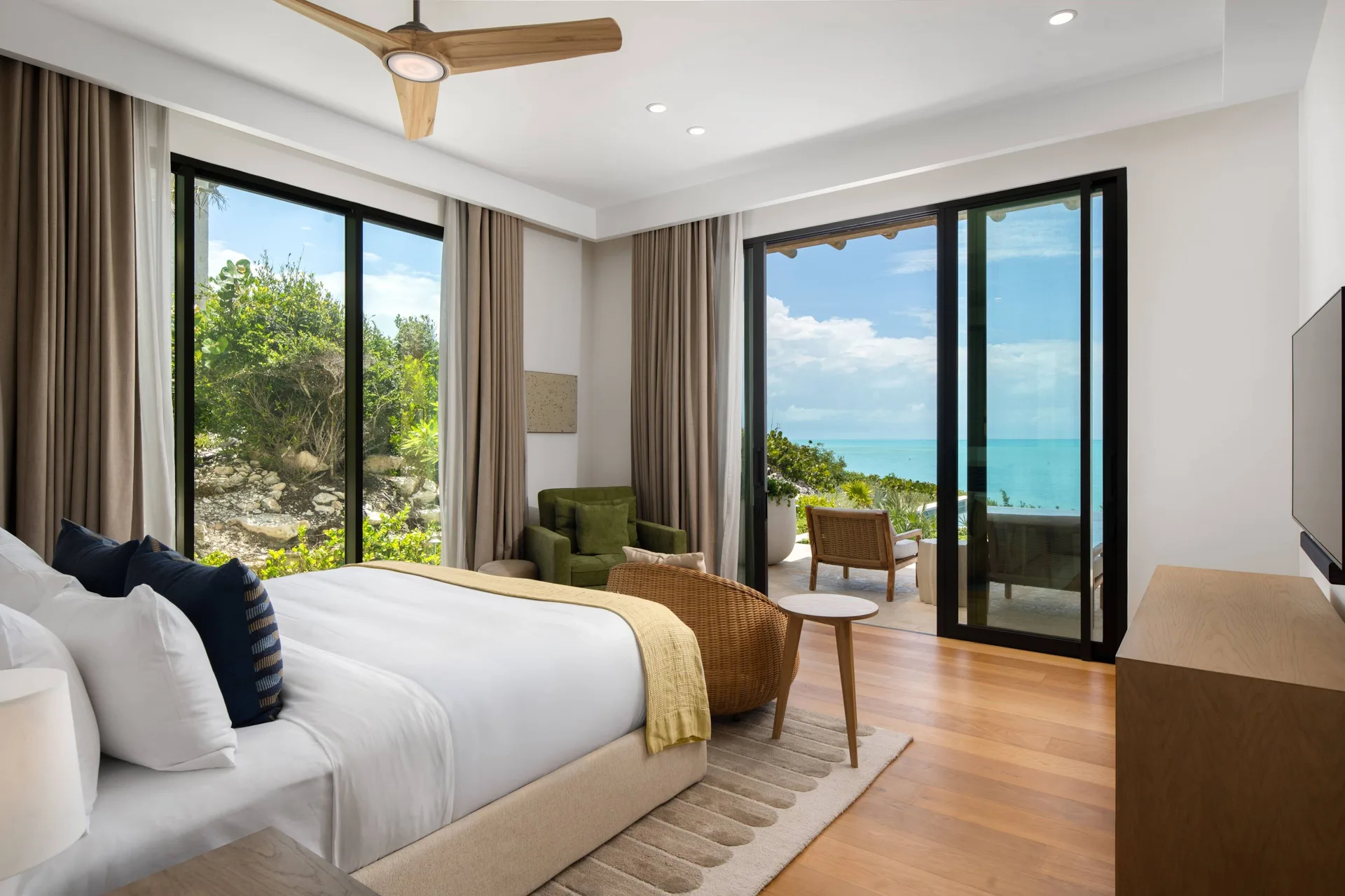 Ocean-view bedroom with king bed and balcony doors at The Strand Turks and Caicos.