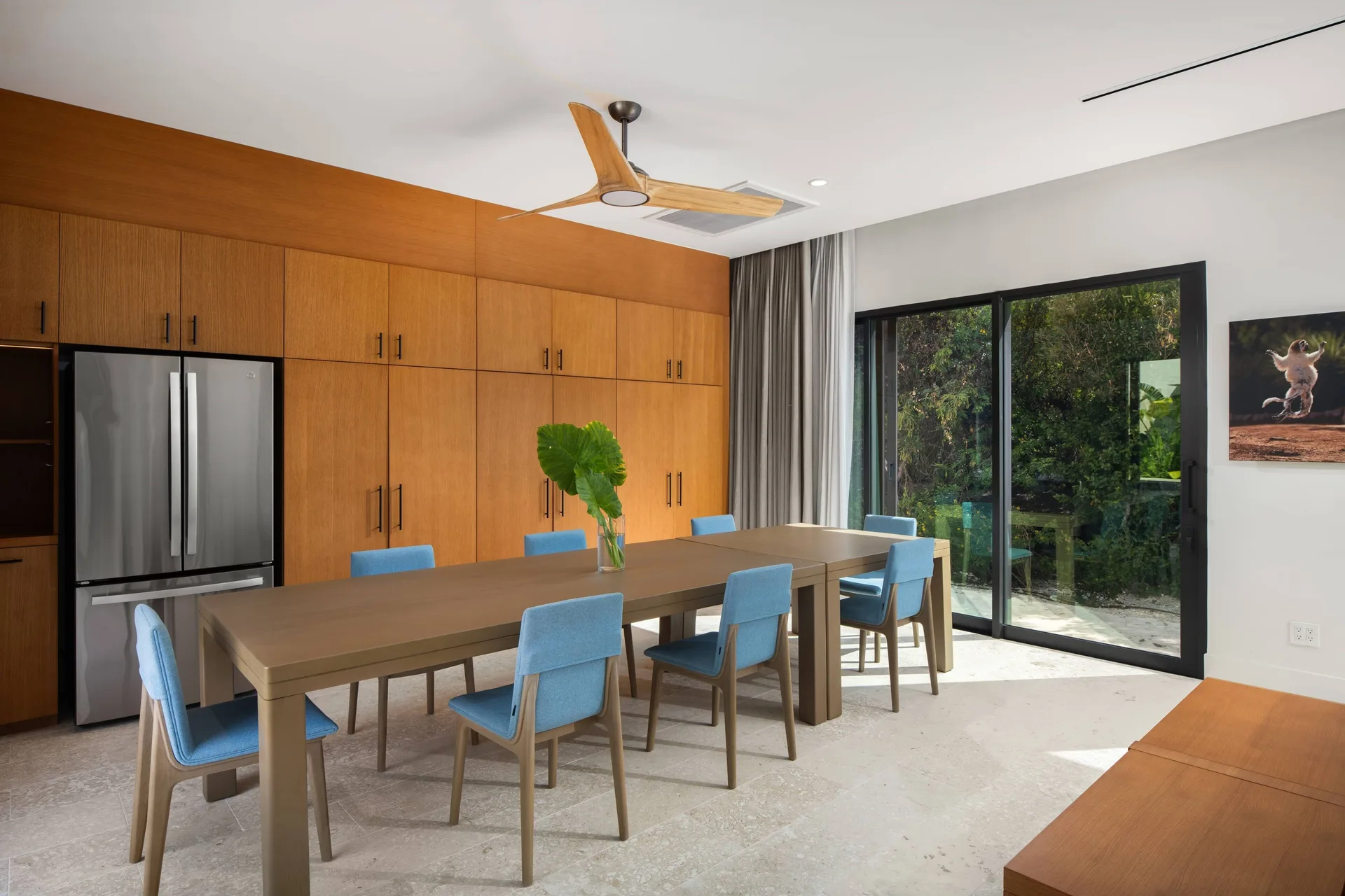 Breakfast table with blue chairs and wood cabinetry at The Strand Turks and Caicos.