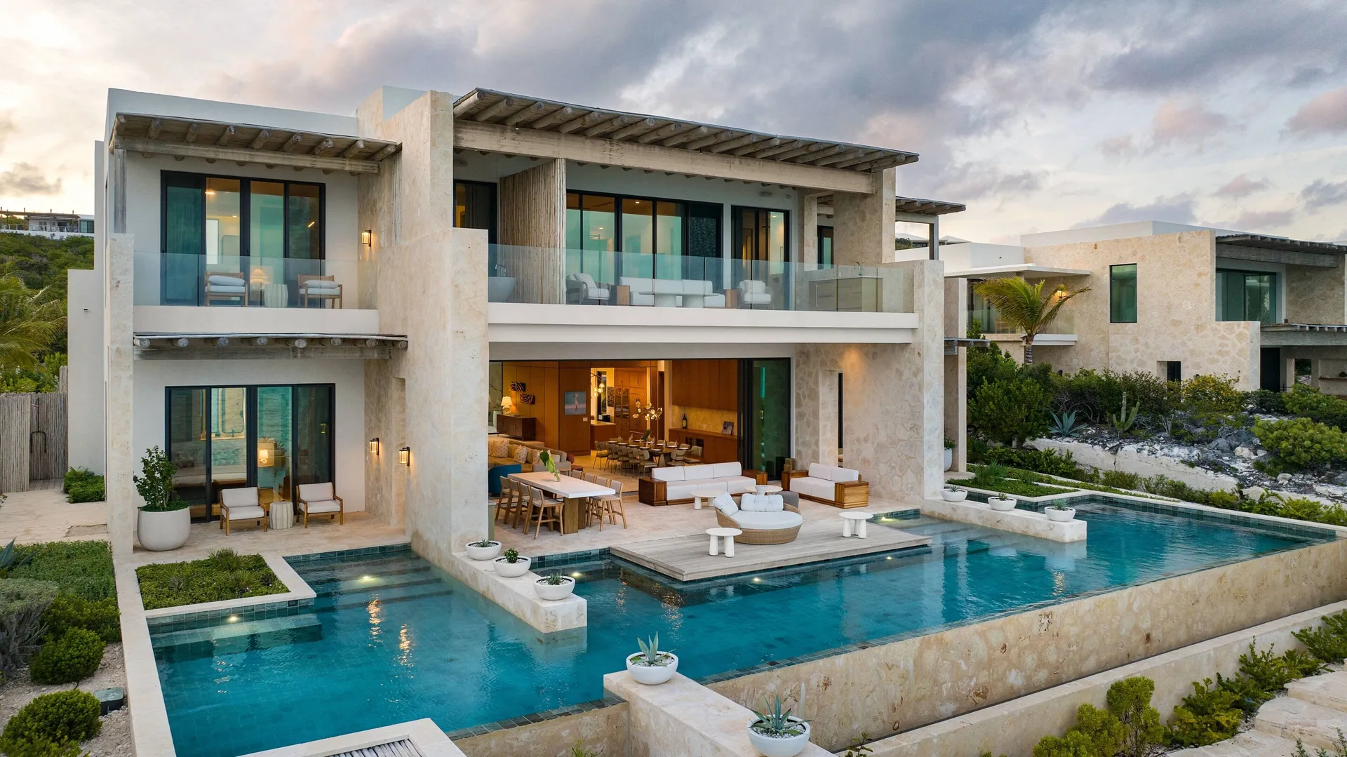 Exterior of the Grand Residence with pool terraces at The Strand Turks and Caicos.