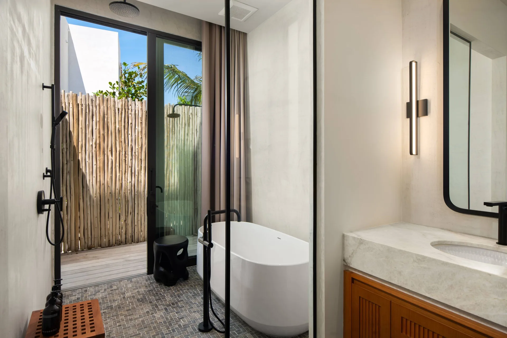 Grand Residence bathroom with soaking tub and outdoor shower at The Strand Turks and Caicos.