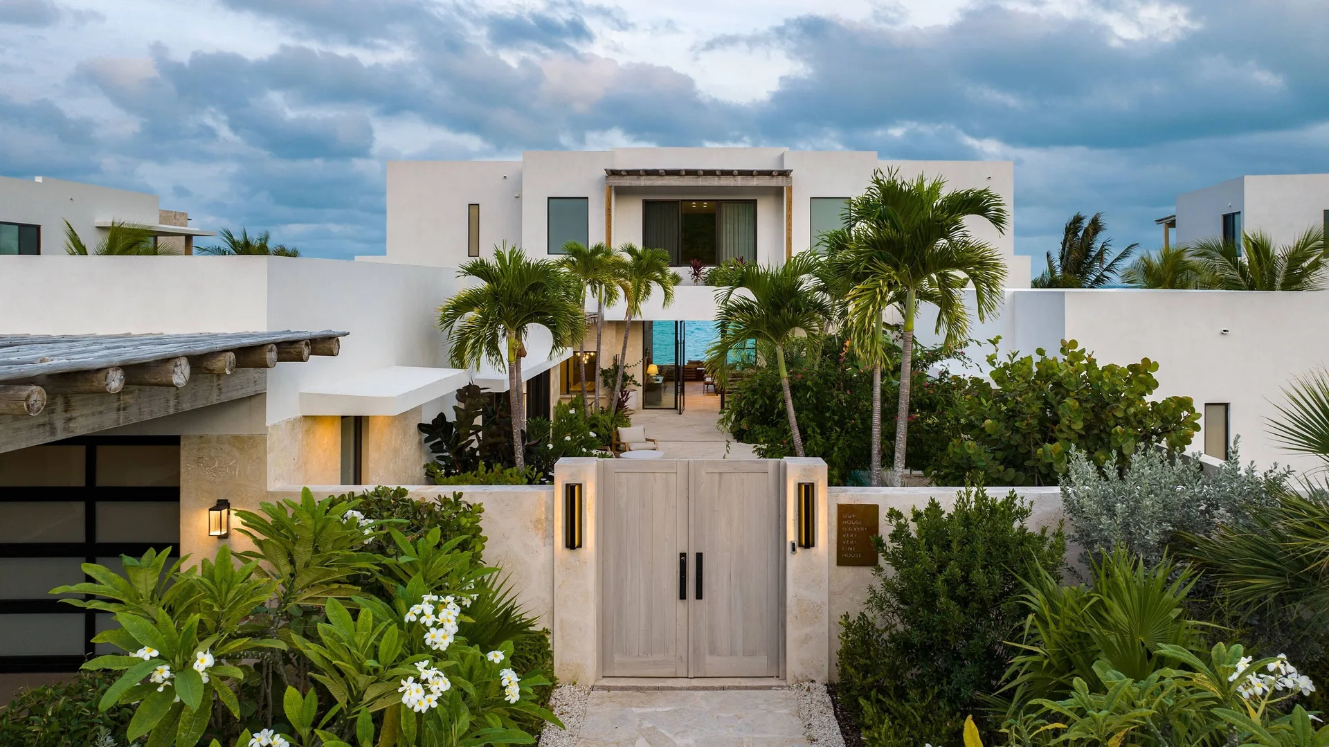 Gated Grand Residence entrance with palms at The Strand Turks and Caicos.