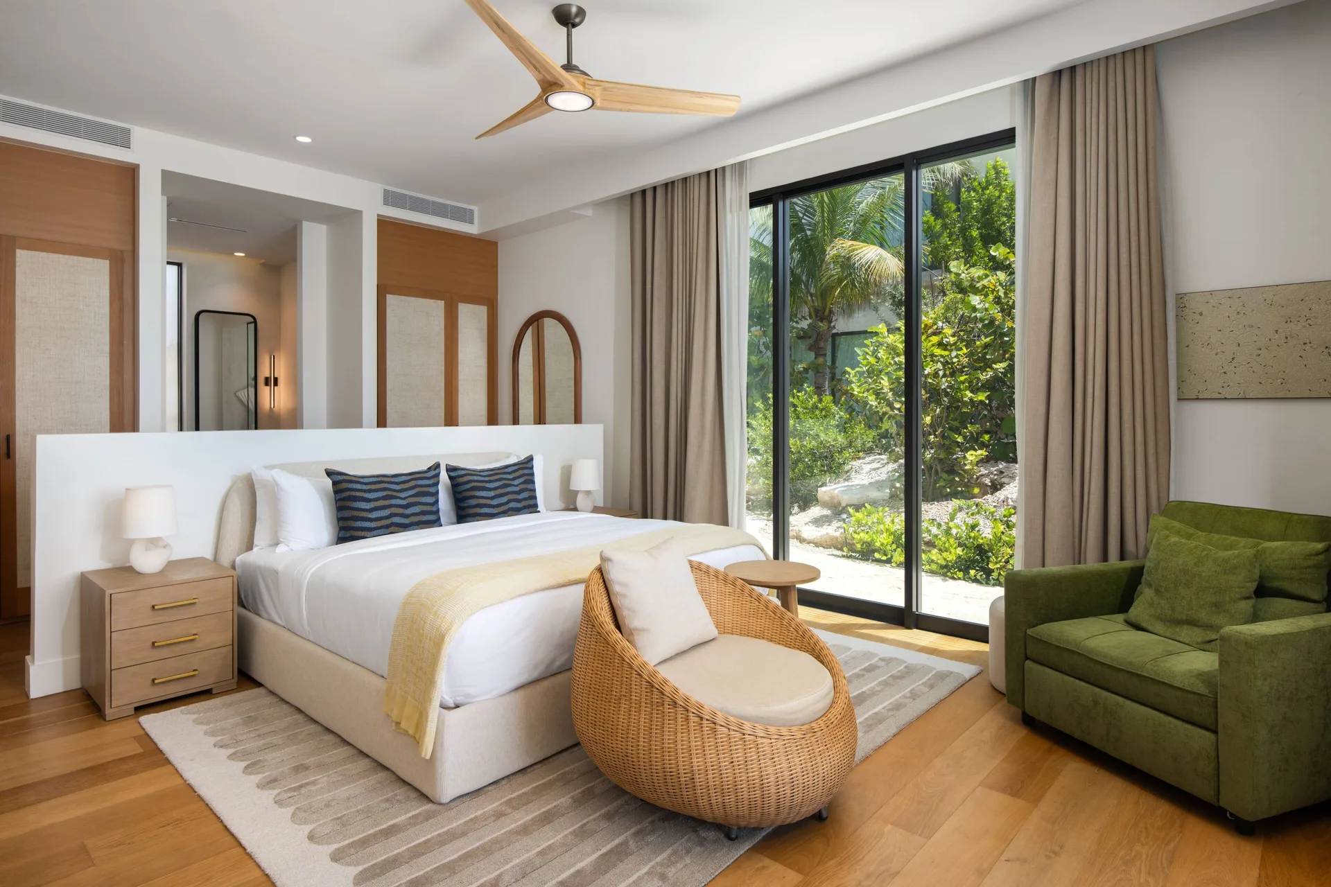 King bedroom with garden-facing glass doors at The Strand Turks and Caicos.