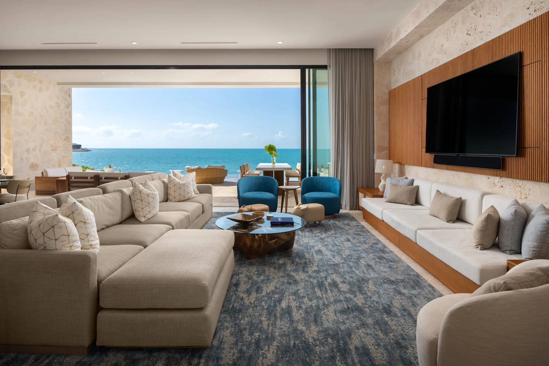 Living room with sectional seating and ocean view at The Strand Turks and Caicos.