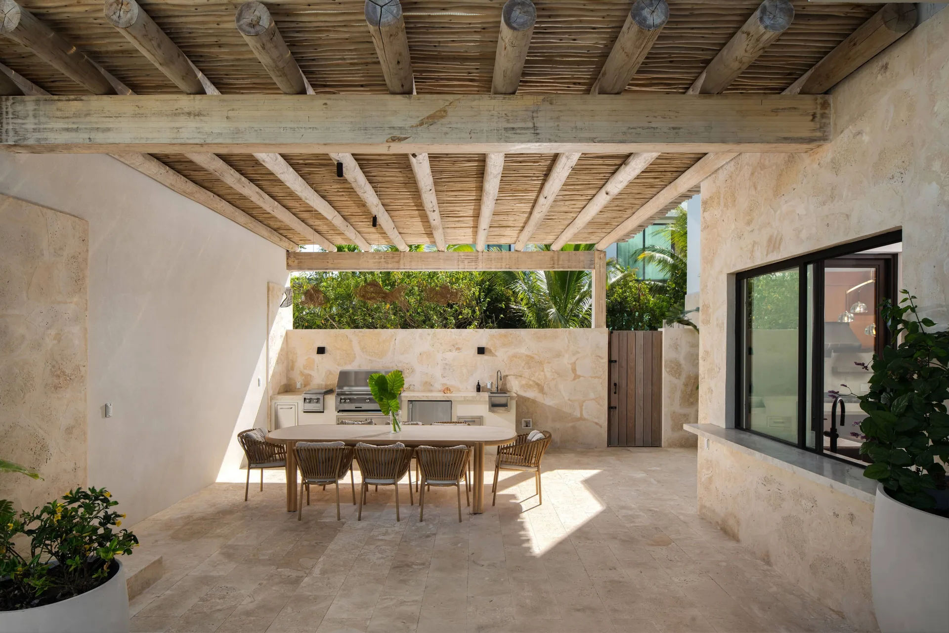 Covered outdoor dining area with grill and kitchen at The Strand Turks and Caicos.