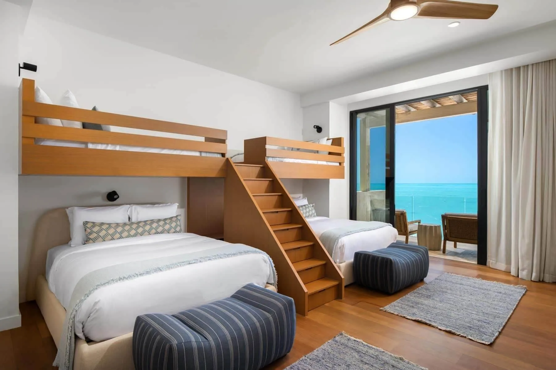 Bunk bedroom with queen beds and ocean balcony at The Strand Turks and Caicos.